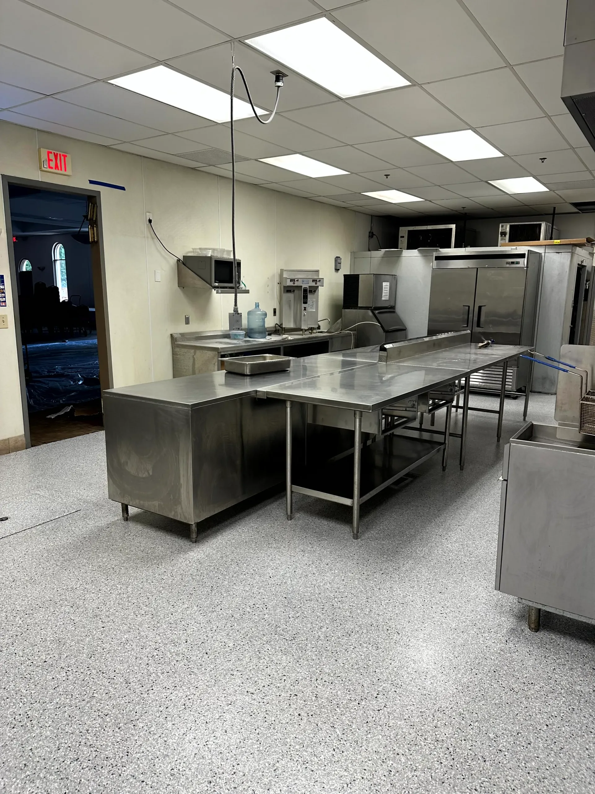 Commercial kitchen with newly installed, clean epoxy floor Another angle of commercial kitchen with newly installed, clean epoxy floor